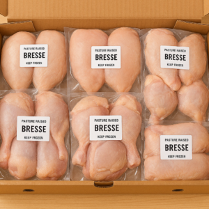 Heritage Platter Bresse Chicken Box with six boneless breasts and six leg quarters vacuum-sealed in shipping box.